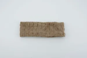 Beige pleated elastic knit headband detail, showing soft textured fabric and vertical stripes.