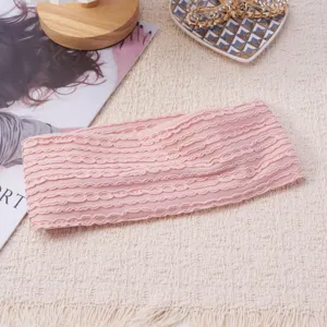 Detailed shot of the pink knitted frill headband, showing soft fabric texture and elastic band.