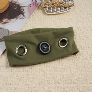 Punk style olive green elastic fabric headband featuring a large black button and metallic grommets.