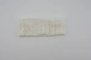 Detail of white pleated stretch knit headband, ideal for yoga, sports and daily hair styling.
