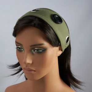 Close-up detail of green fabric headband with metal eyelets and large black button decor.
