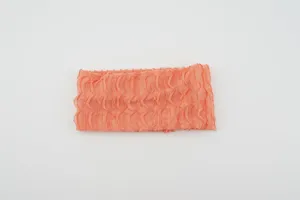 Orange elastic knitted headband detail, featuring vertical ruffles and soft texture.