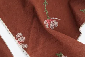 Detail view of vintage caramel embroidered floral triangle headscarf with delicate lace trim.