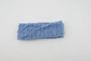 Blue stretchy knit fabric headband with vertical ruffles and frilly edge design for daily wear.