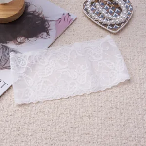 Detailed view of the white vintage paisley lace headband, showing delicate floral and wavy edges.