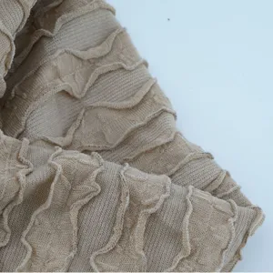 Beige stretch knit headband fabric with ruffles and vertical stripes for hair accessories.