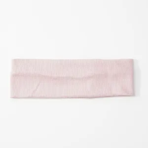Pink ribbed knit headband detail, soft elastic sports fitness hair band close up view