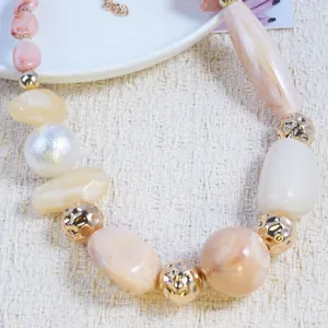 Chunky resin marble bead necklace detail, pink and gold tone fashion collar statement jewelry.