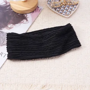Detailed close-up of the black knitted wide headband showing delicate textured wave edge fabric.