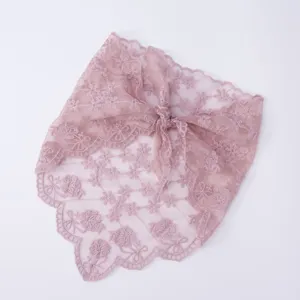 Detailed shot of dusty pink lace floral embroidered triangle headscarf with scalloped edge.