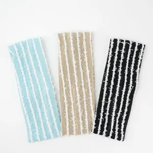 Close-up detail of the knitted striped headband showing soft texture and fine lines.