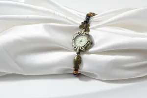 Vintage bronze beaded woven bracelet watch for women, stylish quartz wristwatch with cute charms.