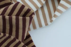 Close-up detail of retro striped knitted fabric, soft texture and elastic material showcase.