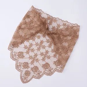 Detailed view of brown lace floral embroidery triangle veil scarf, delicate wavy edge.