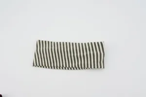 Close-up view of the green and white striped knitted wide headband, elastic yoga hair accessory.