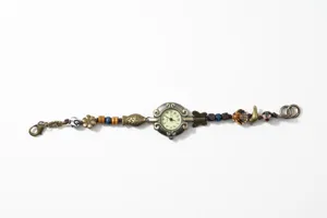 Vintage bronze braided bead watch detail showing unique fish butterfly charms quartz movement