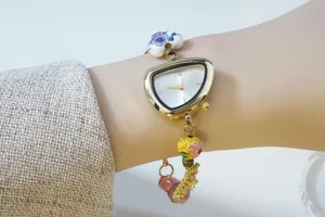 Detail shot of irregular triangle dial women quartz watch with colorful ceramic enamel bead bracelet.
