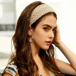 Close-up of a stylish beige mesh knit headband worn by a model, showcasing texture and fit.