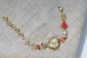 Gold heart dial quartz watch with cute fruit and flower charms bracelet style.