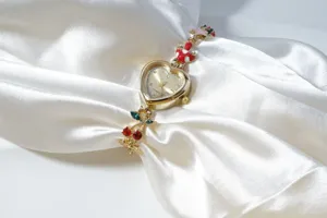 Gold heart-shaped dial quartz bracelet watch with cute cherry and mushroom charms detail.