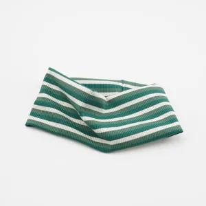 Detailed view of the striped knitted wide yoga headband, showing texture and color details.