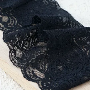 Black elastic lace trim fabric detail shot, perfect for DIY hair accessories and crafts.