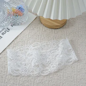 White elastic lace headband detail shot, delicate hollow hair accessory for elegant women.