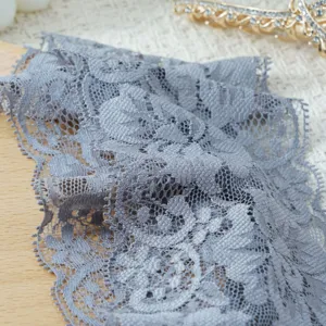 Detailed shot of elastic wide lace headband, featuring elegant hollow floral pattern design.