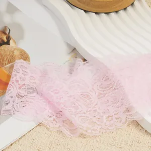 Pink elastic lace trim detail shot, delicate hollow floral pattern for DIY crafts and hair accessories.