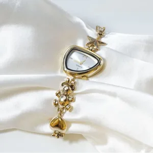 Gold quartz watch with irregular dial, cute bear and star charms, stylish wrist accessory.