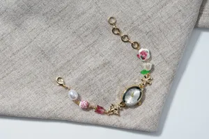 Detailed view of a vintage oval quartz watch bracelet featuring pearls and floral beads.