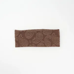 Retro paisley knitted headband for women, wide elastic winter hair band and stylish accessory.
