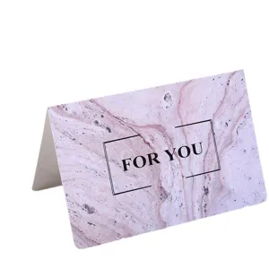 Tarjeta de felicitación plegada con textura de mármol rosa y diseño elegante para regalo y fiesta