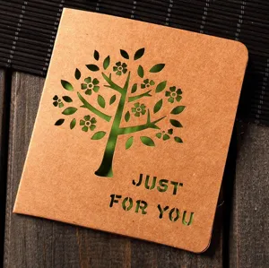 Creative hollow kraft paper greeting card featuring a tree pattern and custom message.