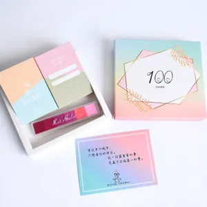 Couple gift box set with 100 things cards and stamp pad, top-down flat lay view.