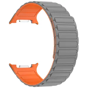 Detailed close-up view of the silicone magnetic watch band featuring dual-tone grey and orange links.
