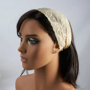 Vintage lace hair band detail showing intricate floral paisley pattern on a stylish wide headband.