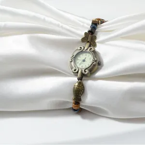 Vintage bronze beaded woven bracelet watch featuring cute fish and butterfly charms for women.