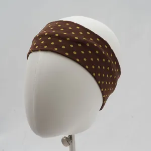 Detailed view of the brown polka dot knitted wide headband, soft elastic hair accessory.