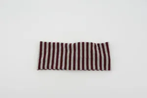 Closeup detail of the retro striped knitted sports headband and elastic hair accessory.