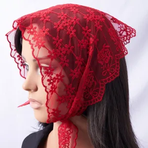 Red lace chapel veil detail showing delicate floral embroidery and scalloped edge design.