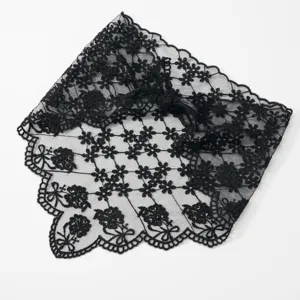Black lace triangular veil detail showing delicate floral embroidery and elegant scalloped edge design.