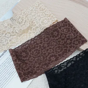 Elastic wide lace headband detail showing floral pattern in beige, brown and black.