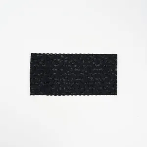Black lace headband detail view, elastic floral lace hair accessory for women.