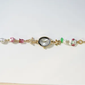 Elegant vintage oval quartz watch with pearl and ceramic floral beaded bracelet for women
