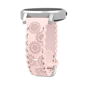 Detailed view of the light pink silicone watch strap featuring hollow carved sunflower patterns.
