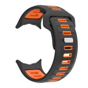 Detailed close-up of the black and orange silicone replacement watch band texture.