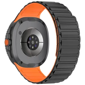 Detailed view of black orange magnetic silicone watch band back sensor area and metal links.