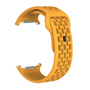 Close-up view of orange perforated silicone watch band with breathable holes and metal buckle.