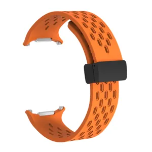 Silicone perforated watch band detail view, orange breathable design with magnetic clasp.